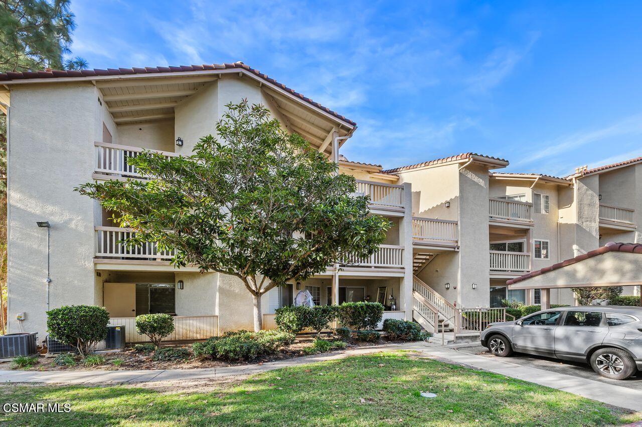 697 Sutton Crest Trail, Unit 302 Oak Park, CA 91377 - Photo 46 of 47 a front view of a house with garden