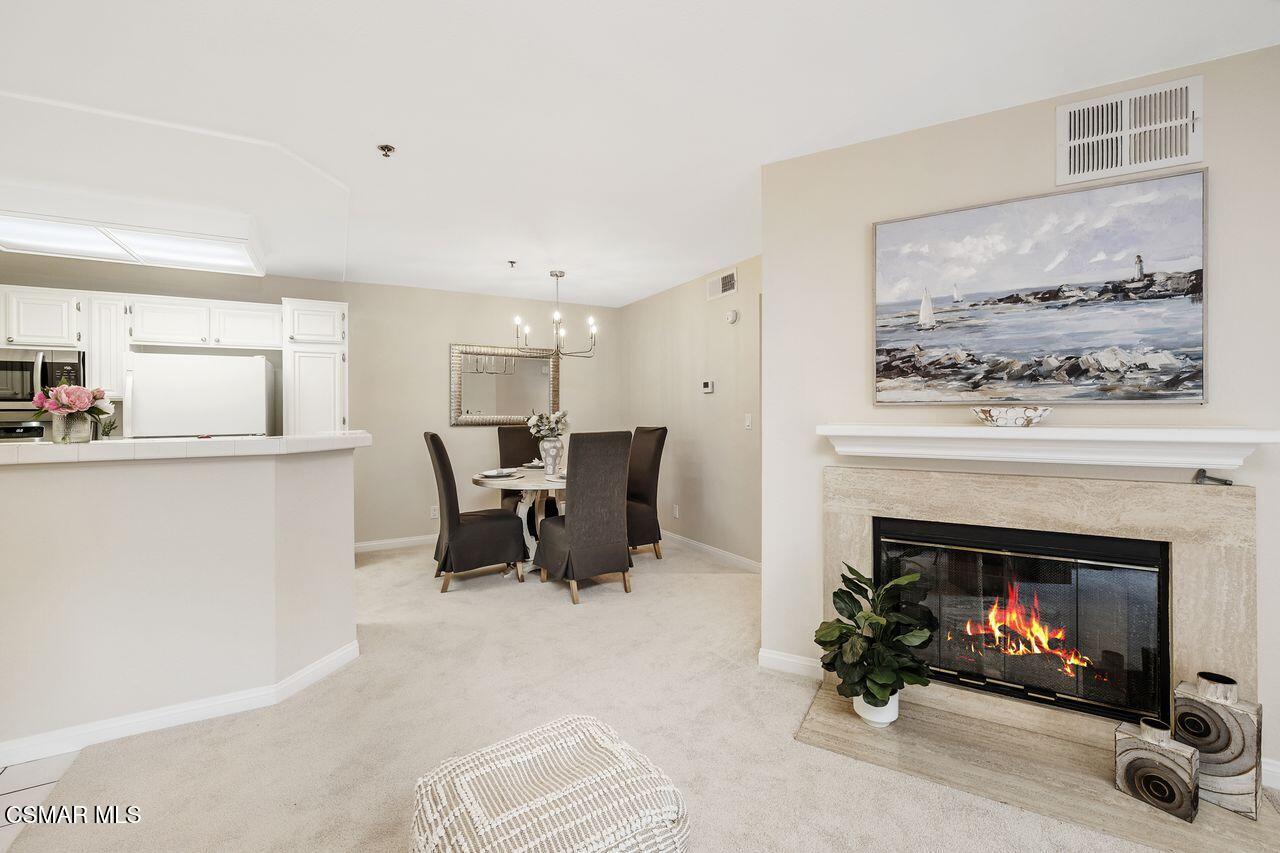 697 Sutton Crest Trail, Unit 302 Oak Park, CA 91377 - Photo 5 of 47 a living room with furniture and a fireplace