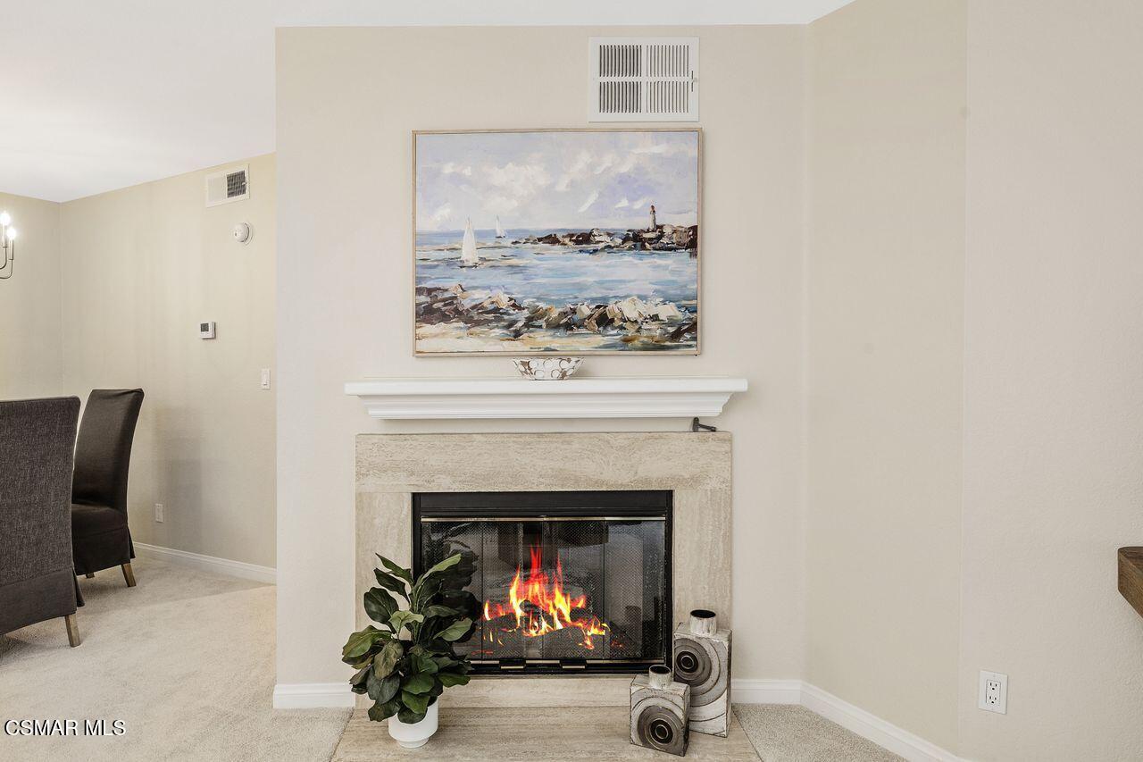 697 Sutton Crest Trail, Unit 302 Oak Park, CA 91377 - Photo 6 of 47 a living room with furniture and a fireplace