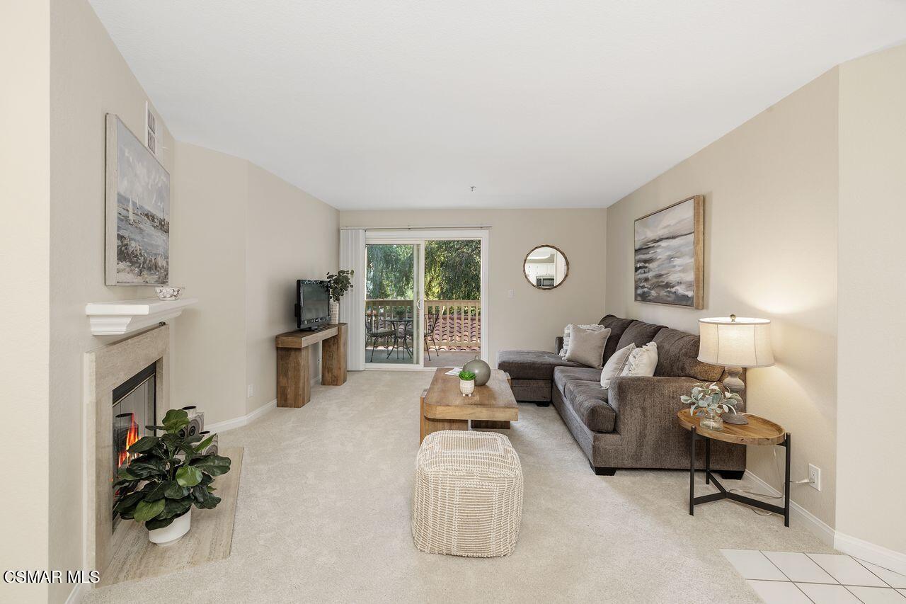 697 Sutton Crest Trail, Unit 302 Oak Park, CA 91377 - Photo 7 of 47 a living room with furniture fireplace and flat screen tv