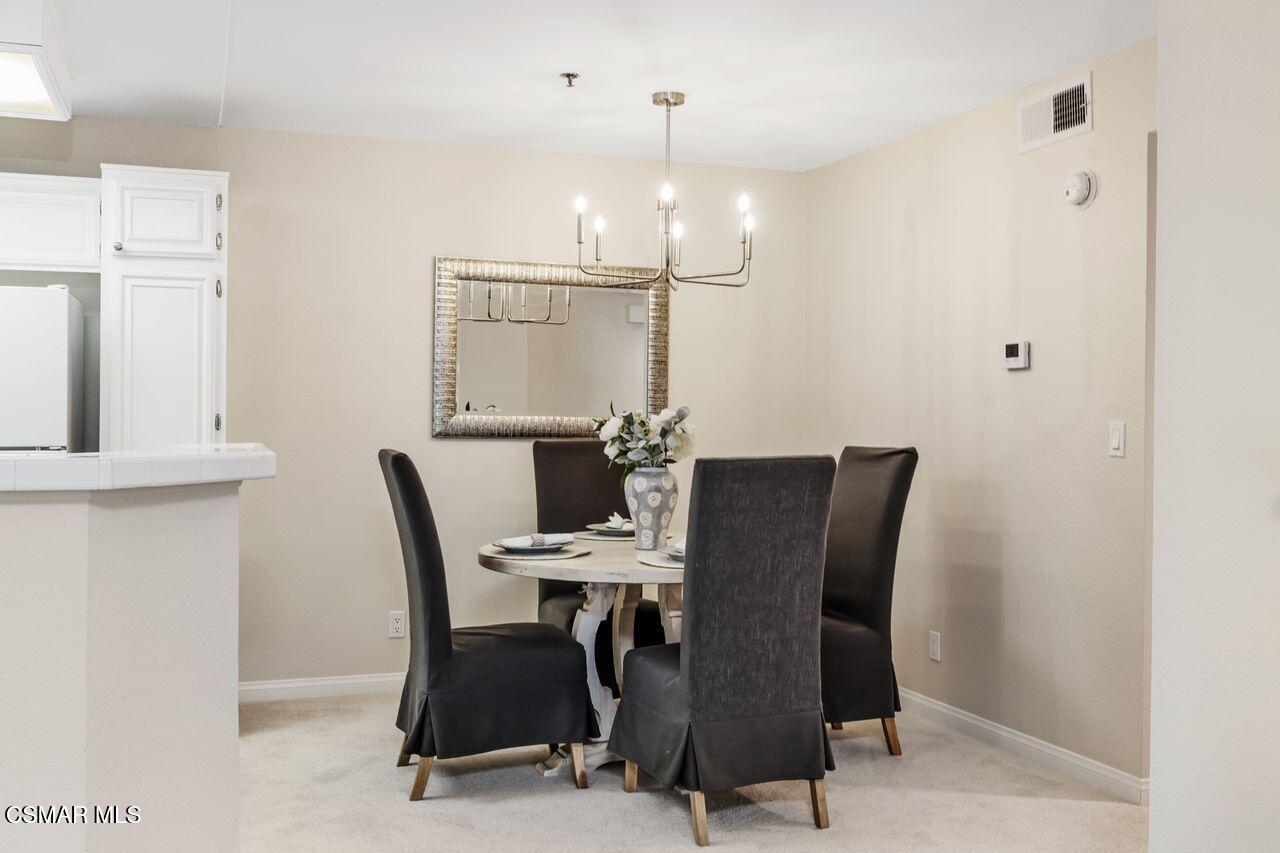 697 Sutton Crest Trail, Unit 302 Oak Park, CA 91377 - Photo 8 of 47 a dining room with furniture and window