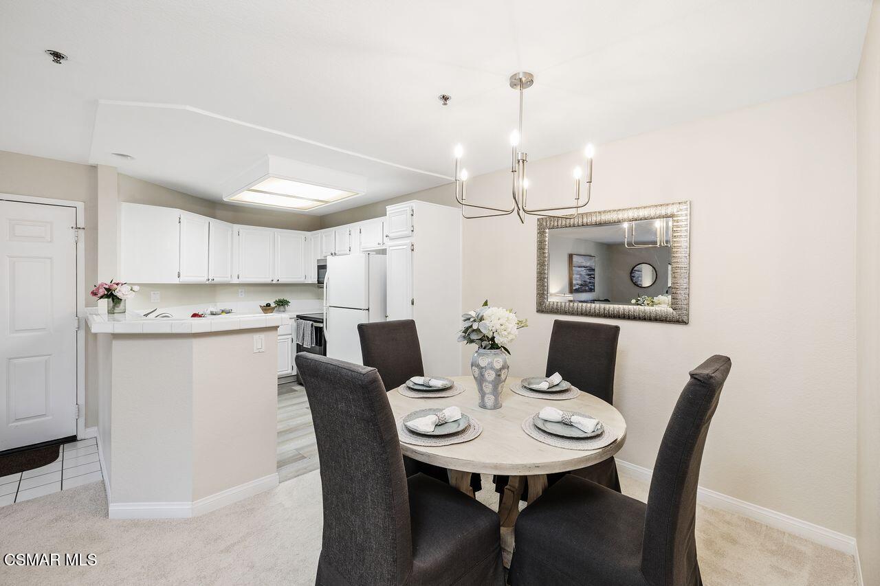 697 Sutton Crest Trail, Unit 302 Oak Park, CA 91377 - Photo 9 of 47 a view of a dining room with furniture