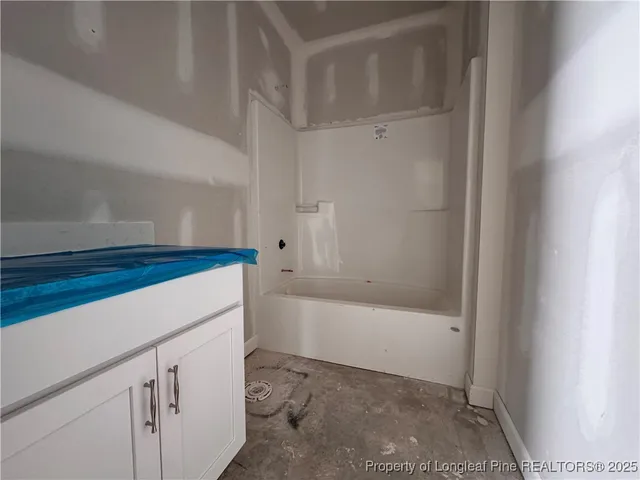 a bathroom with a bathtub and shower