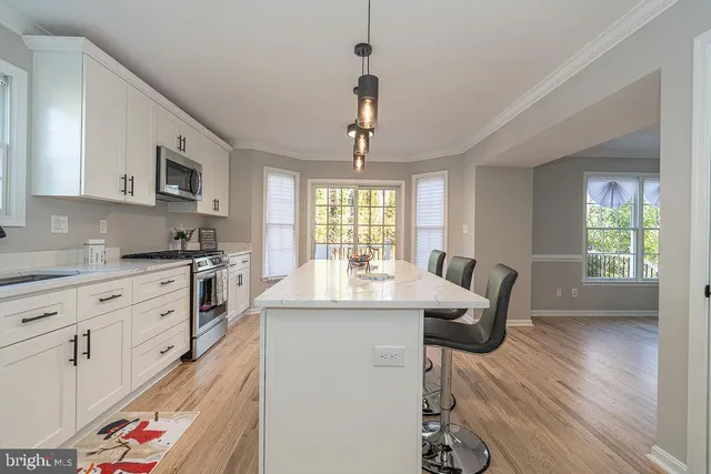 a kitchen with sink cabinets and wooden floor
