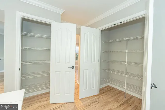 a view of a room with wooden floor