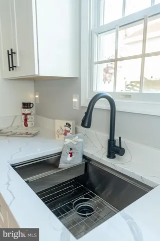a kitchen with a stove a sink and a window
