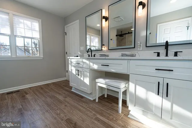a kitchen with a sink cabinets and wooden floor