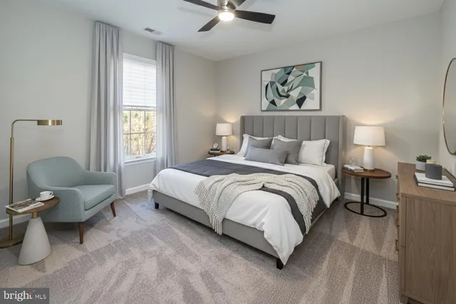 a bed room with a bed and a chair