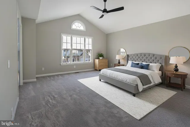 a bedroom with a large bed and a window