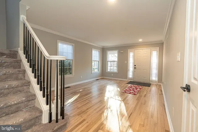 a view of a hallway view with wooden floor and staircase