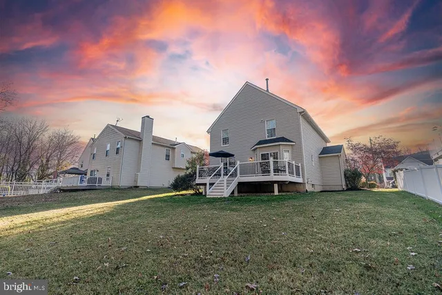 a big house with a big yard and more large trees