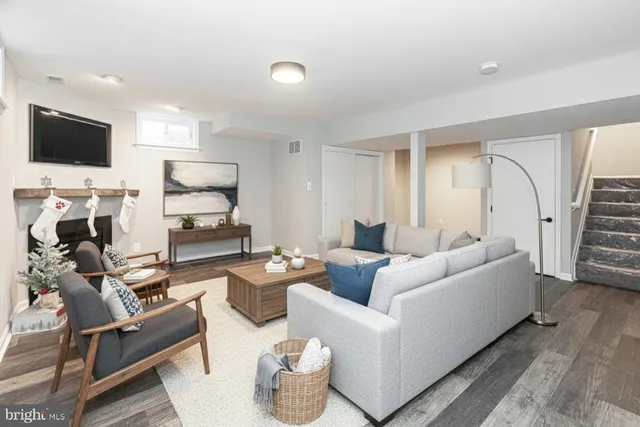 a living room with furniture a flat screen tv and a view of kitchen