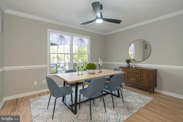 a view of a dining room with a table and chairs