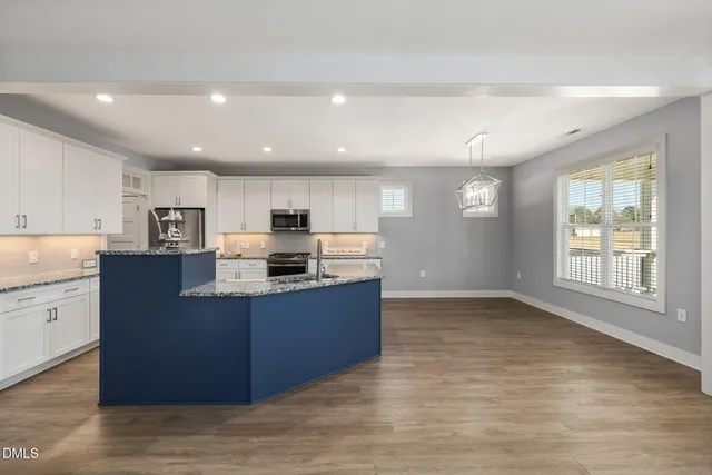 a view of an empty room with a fireplace and a window