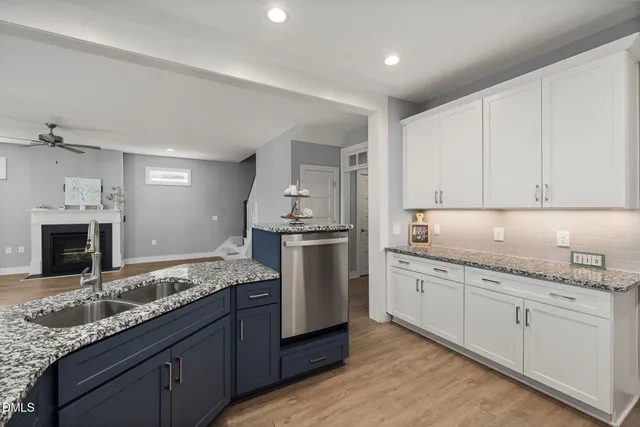 a large kitchen with stainless steel appliances granite countertop a lot of counter space and wooden floor