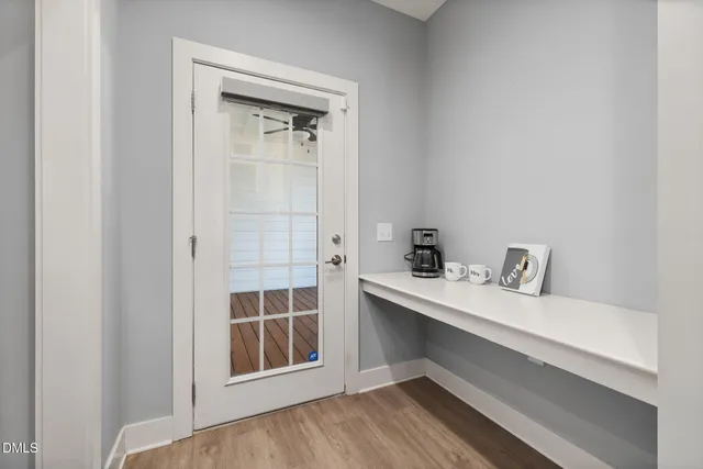 a kitchen with stainless steel appliances granite countertop wooden cabinets granite counter tops and a hard wood floors