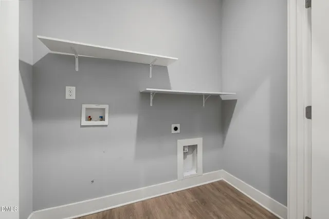 a view of a room with wooden floor and a ceiling fan