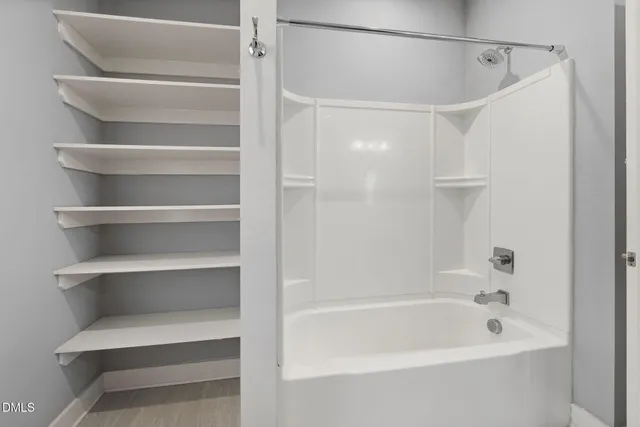 a bathroom with a granite countertop toilet a sink and a mirror
