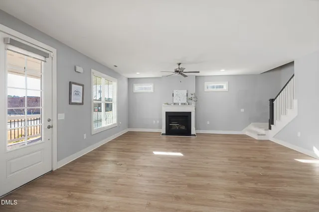 a view of kitchen and hall with wooden floor