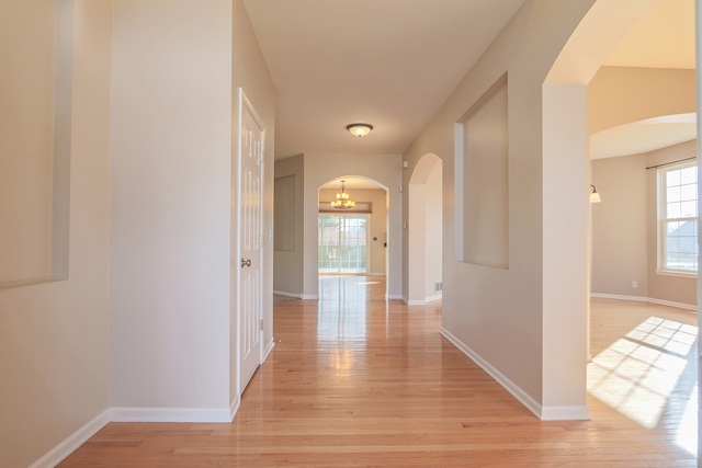 805 Myers Road Sugar Grove, IL 60554 - Photo 4 of 27 a view of a hallway with wooden floor and a bathroom
