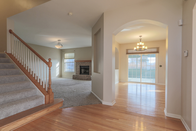 805 Myers Road Sugar Grove, IL 60554 - Photo 5 of 27 a view of a livingroom with wooden floor and staircase