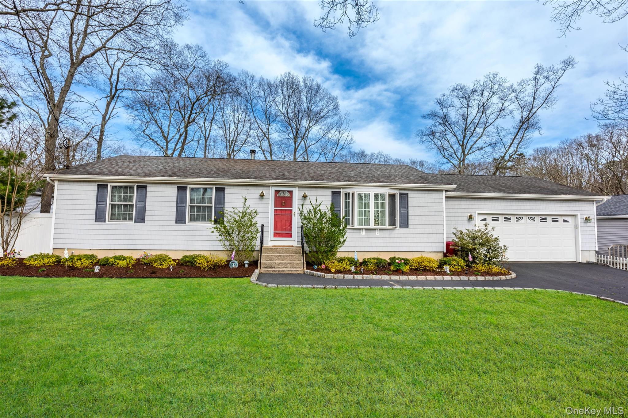 9 South Pond Trail Ridge, NY 11961 - Photo 1 of 40 a front view of house with yard and outdoor seating