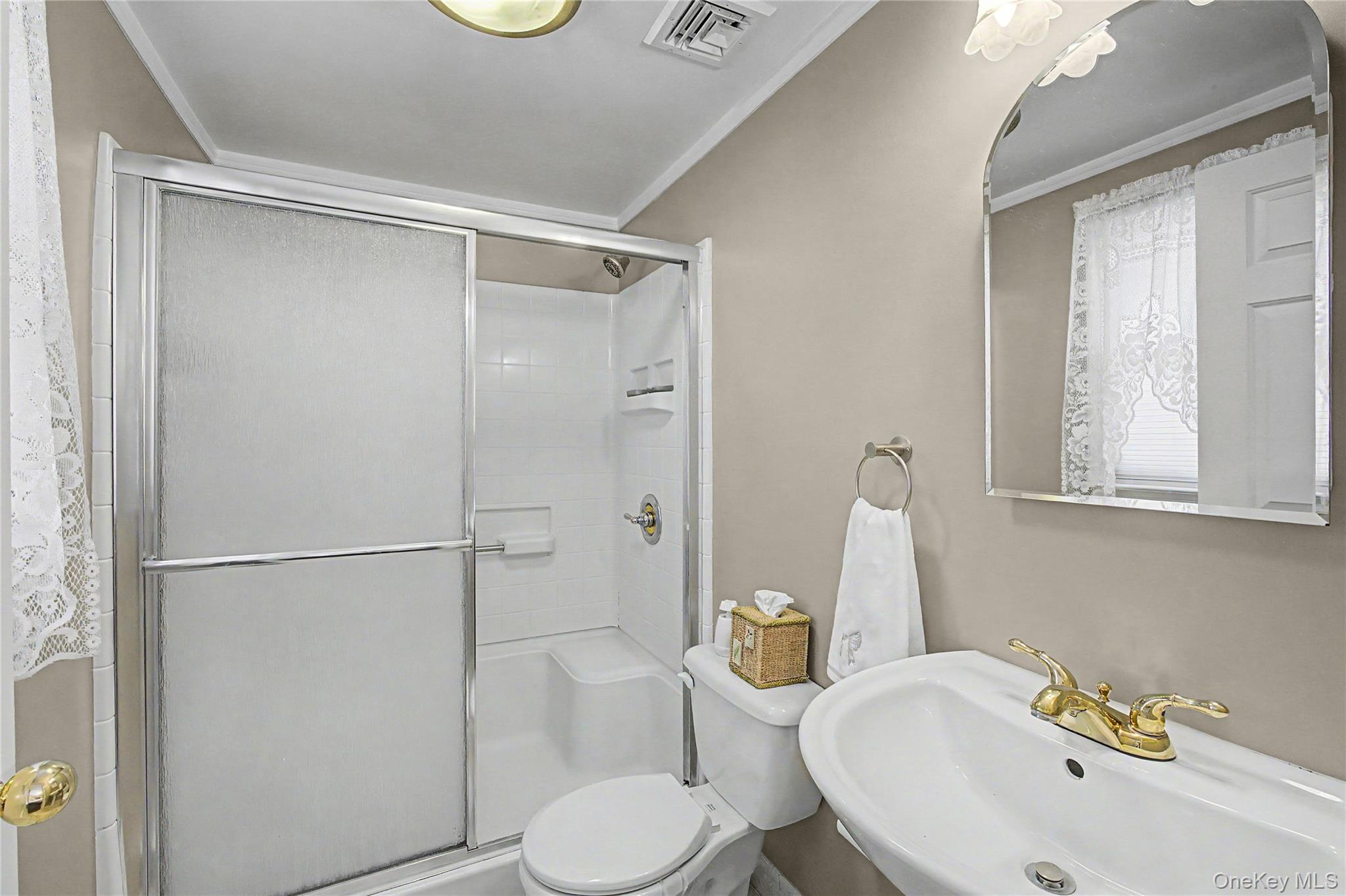 9 South Pond Trail Ridge, NY 11961 - Photo 16 of 40 a bathroom with a sink toilet and shower