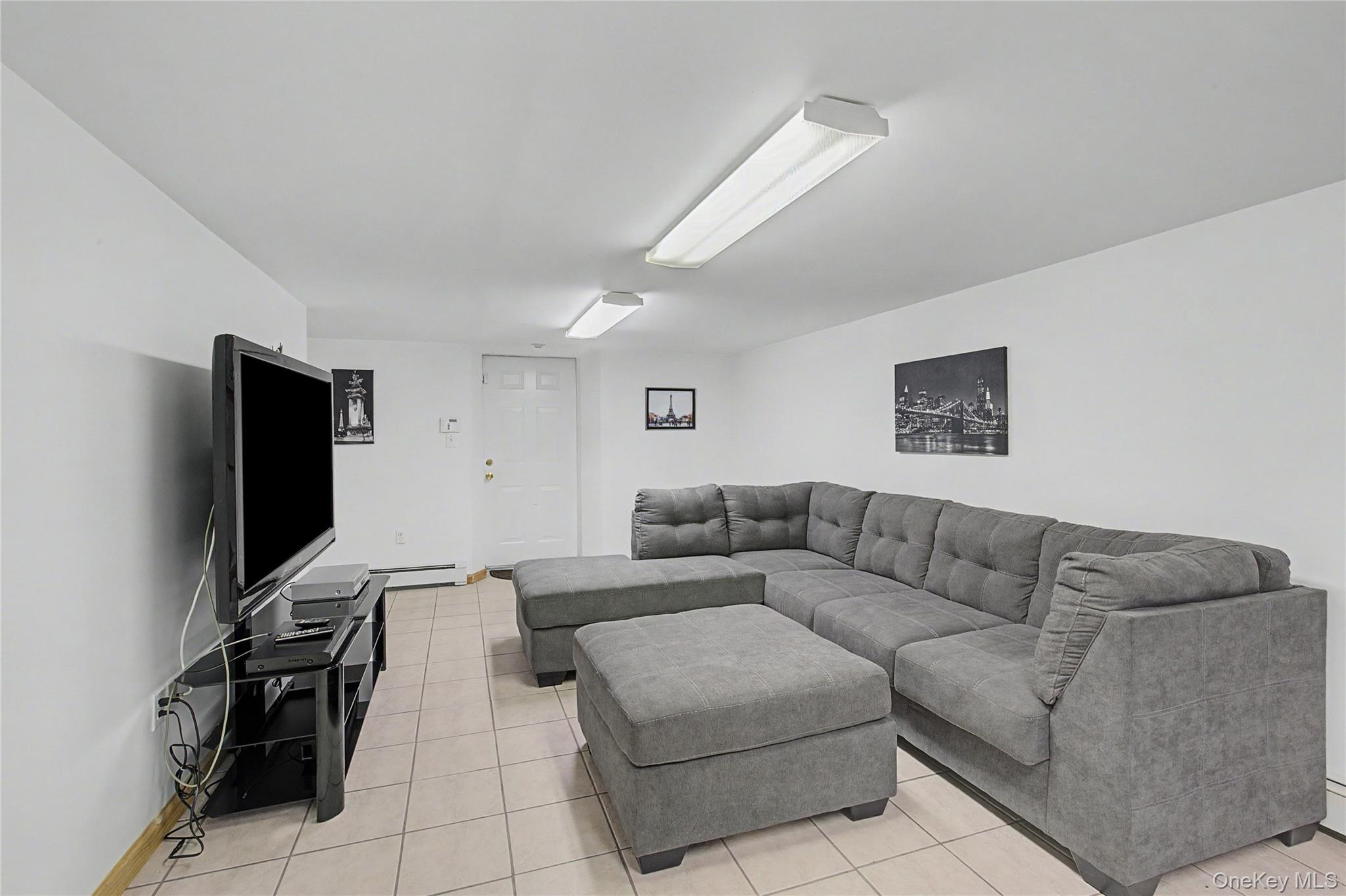 9 South Pond Trail Ridge, NY 11961 - Photo 17 of 40 a living room with furniture and a flat screen tv