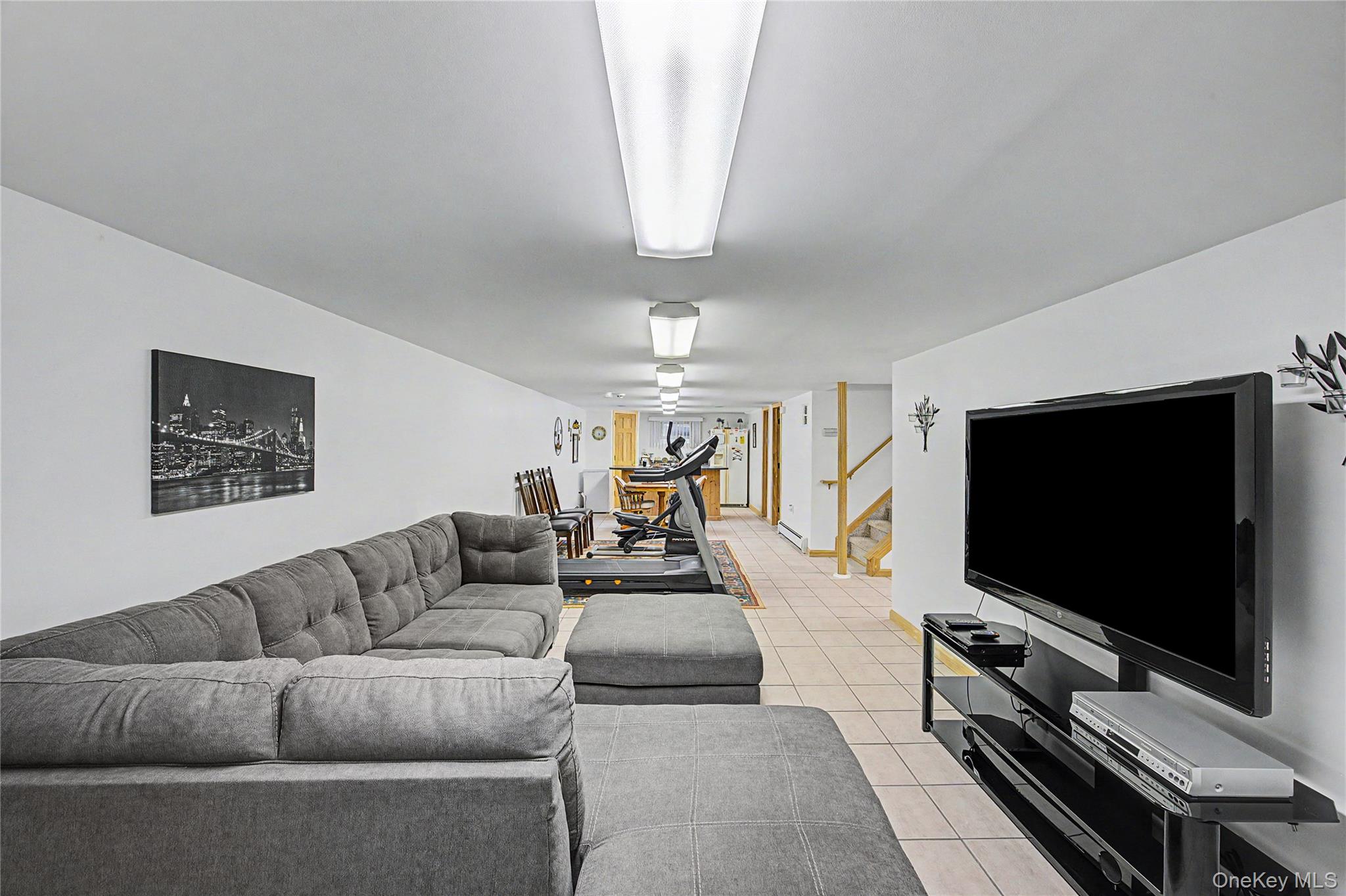 9 South Pond Trail Ridge, NY 11961 - Photo 18 of 40 a living room with furniture and a flat screen tv