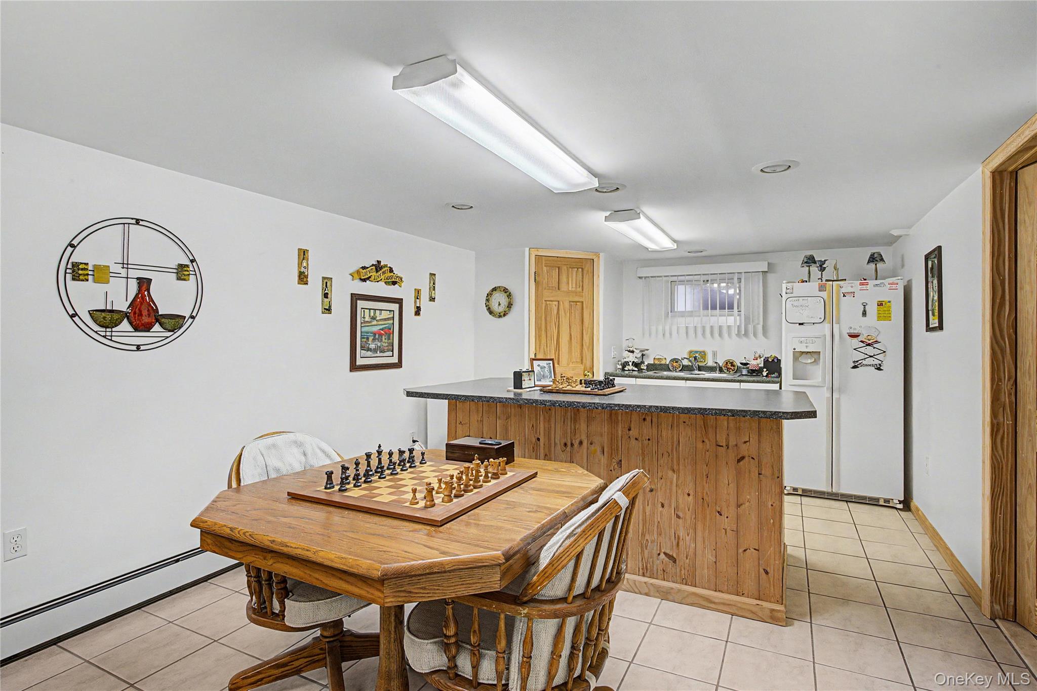 9 South Pond Trail Ridge, NY 11961 - Photo 20 of 40 a view of a dining room with furniture and a chandelier