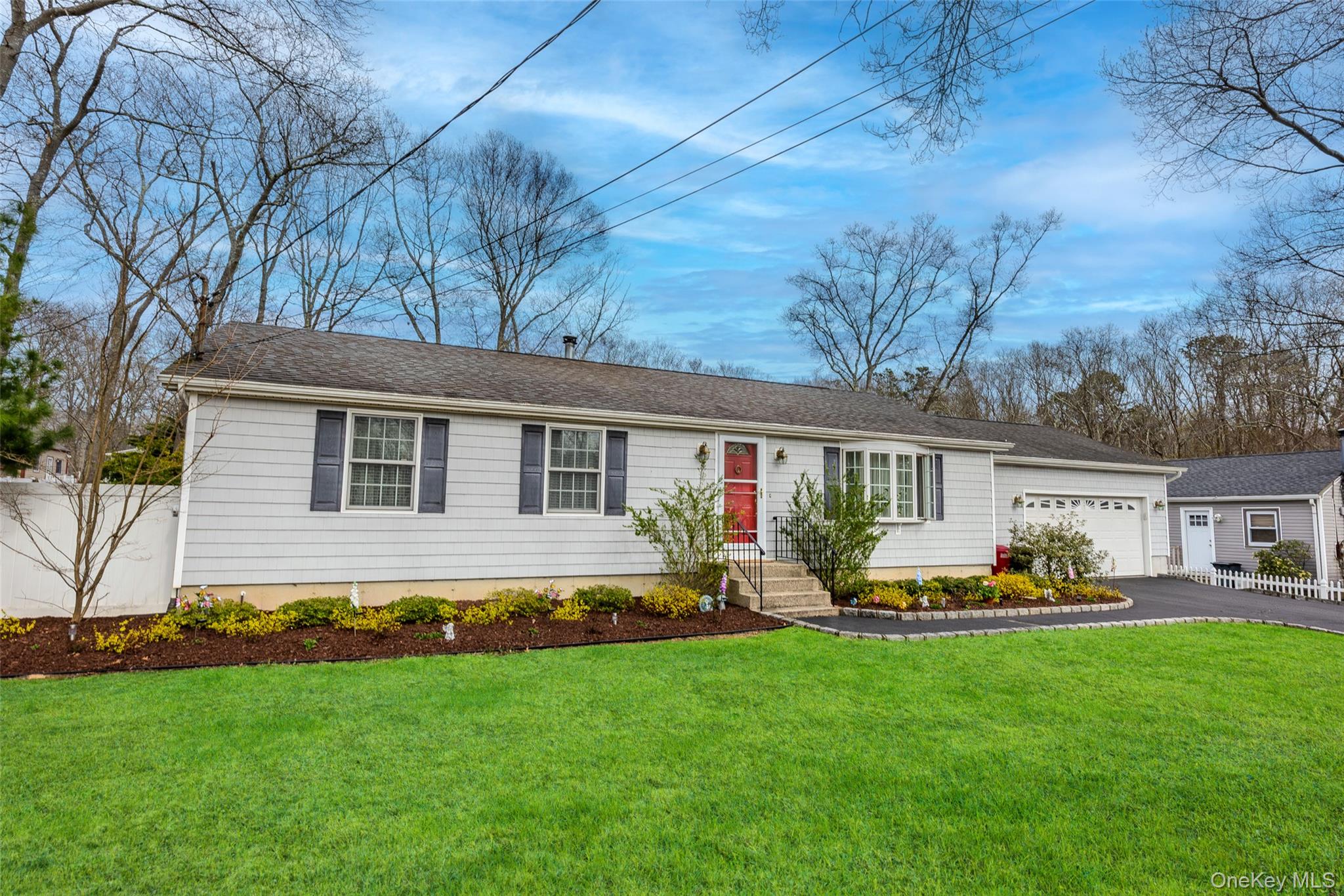 9 South Pond Trail Ridge, NY 11961 - Photo 2 of 40 a front view of house with yard and outdoor seating