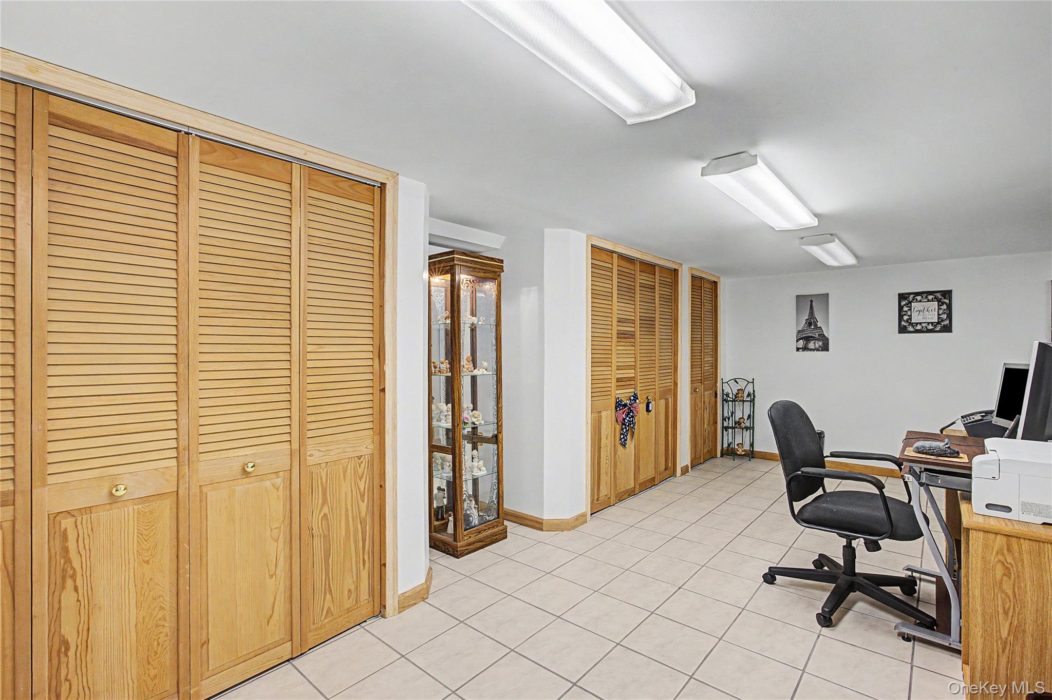 9 South Pond Trail Ridge, NY 11961 - Photo 23 of 40 a view of a workspace with furniture and a window