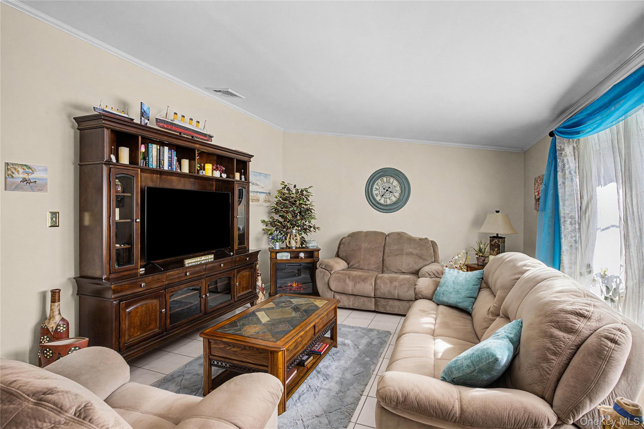 9 South Pond Trail Ridge, NY 11961 - Photo 26 of 40 a living room with furniture and a flat screen tv