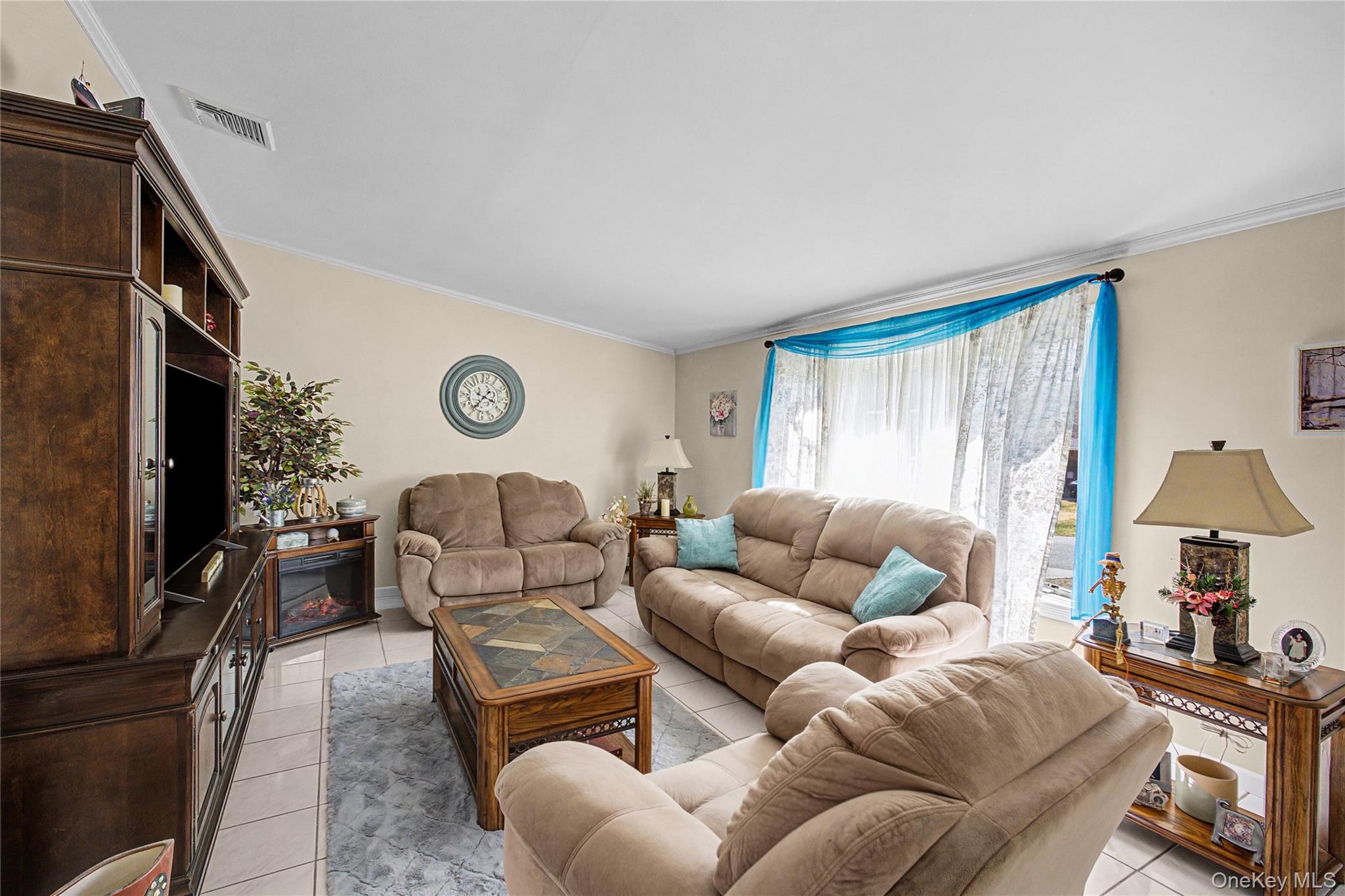 9 South Pond Trail Ridge, NY 11961 - Photo 27 of 40 a living room with furniture and a flat screen tv