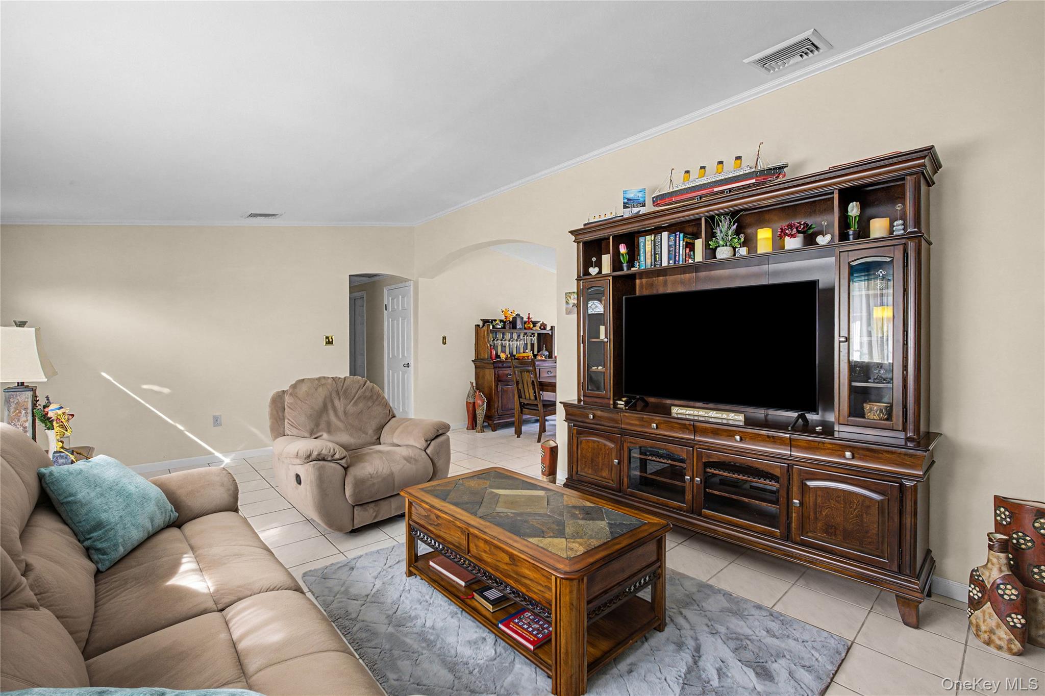 9 South Pond Trail Ridge, NY 11961 - Photo 28 of 40 a living room with furniture and a flat screen tv