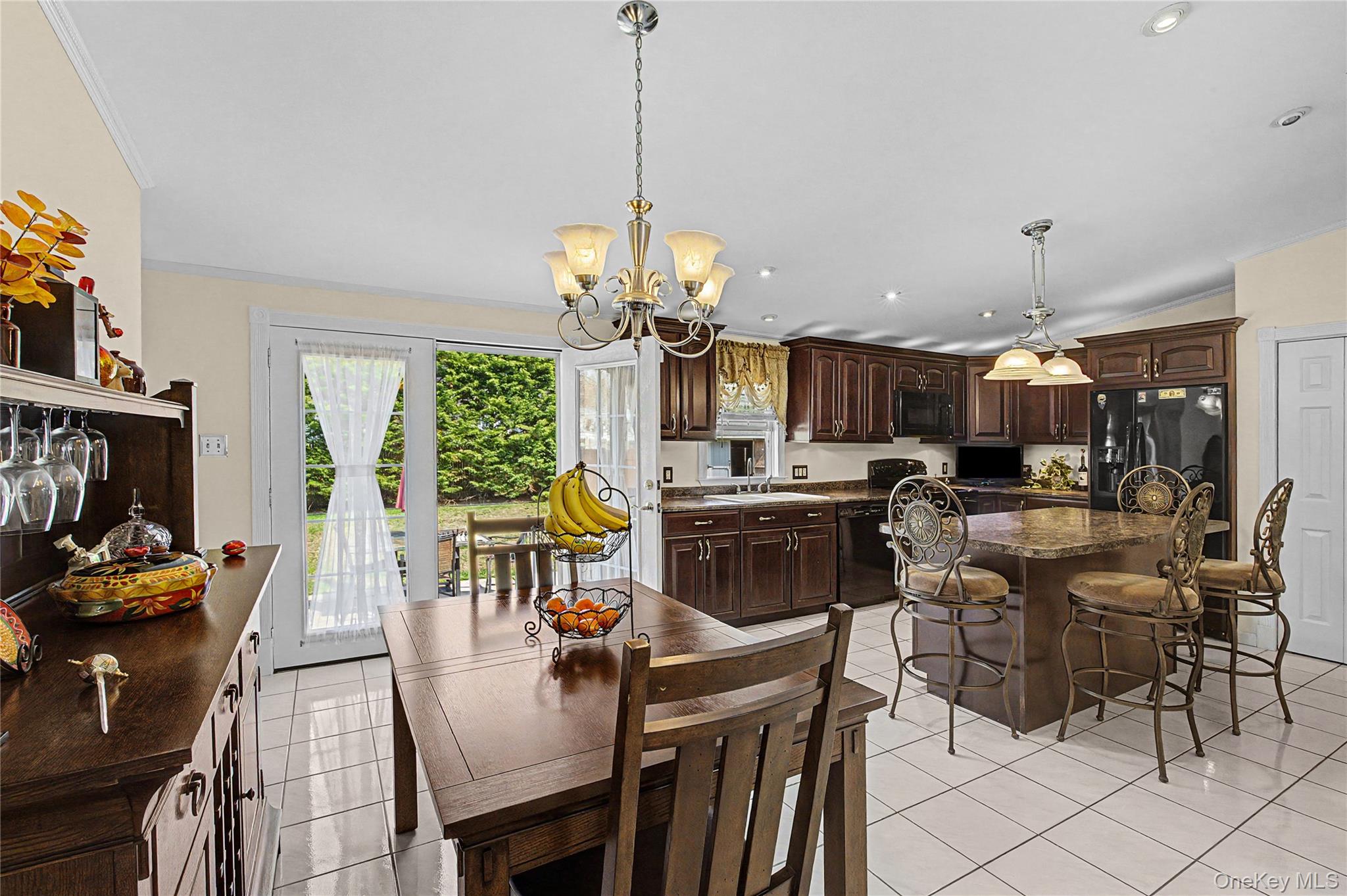 9 South Pond Trail Ridge, NY 11961 - Photo 29 of 40 a dining room filled chandelier and kitchen view