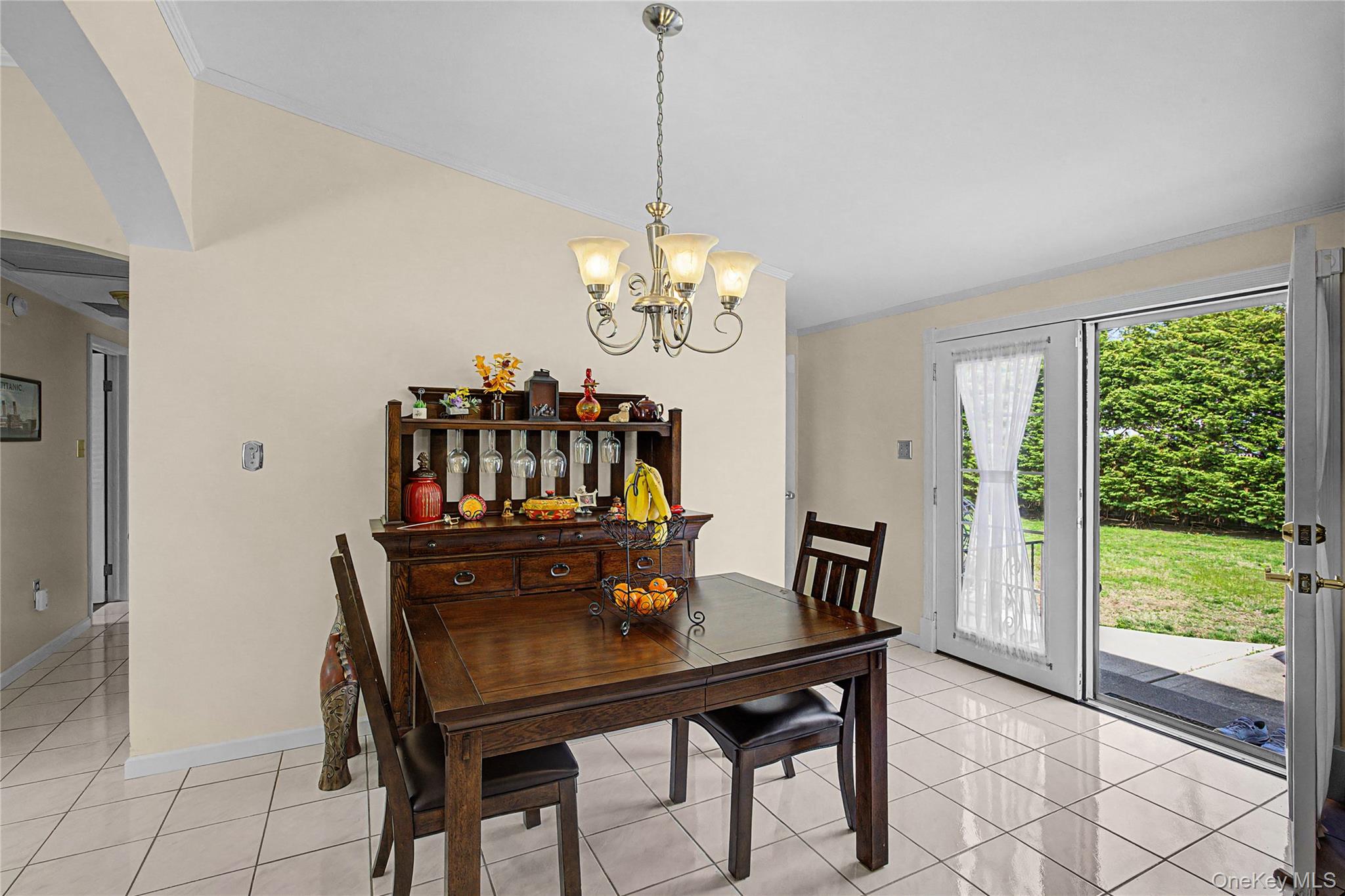 9 South Pond Trail Ridge, NY 11961 - Photo 30 of 40 a view of a dining room with furniture a chandelier and wooden floor