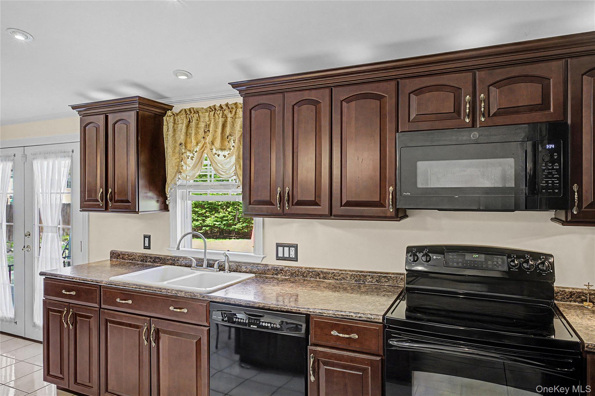 9 South Pond Trail Ridge, NY 11961 - Photo 33 of 40 a kitchen with granite countertop stainless steel appliances and wooden cabinets