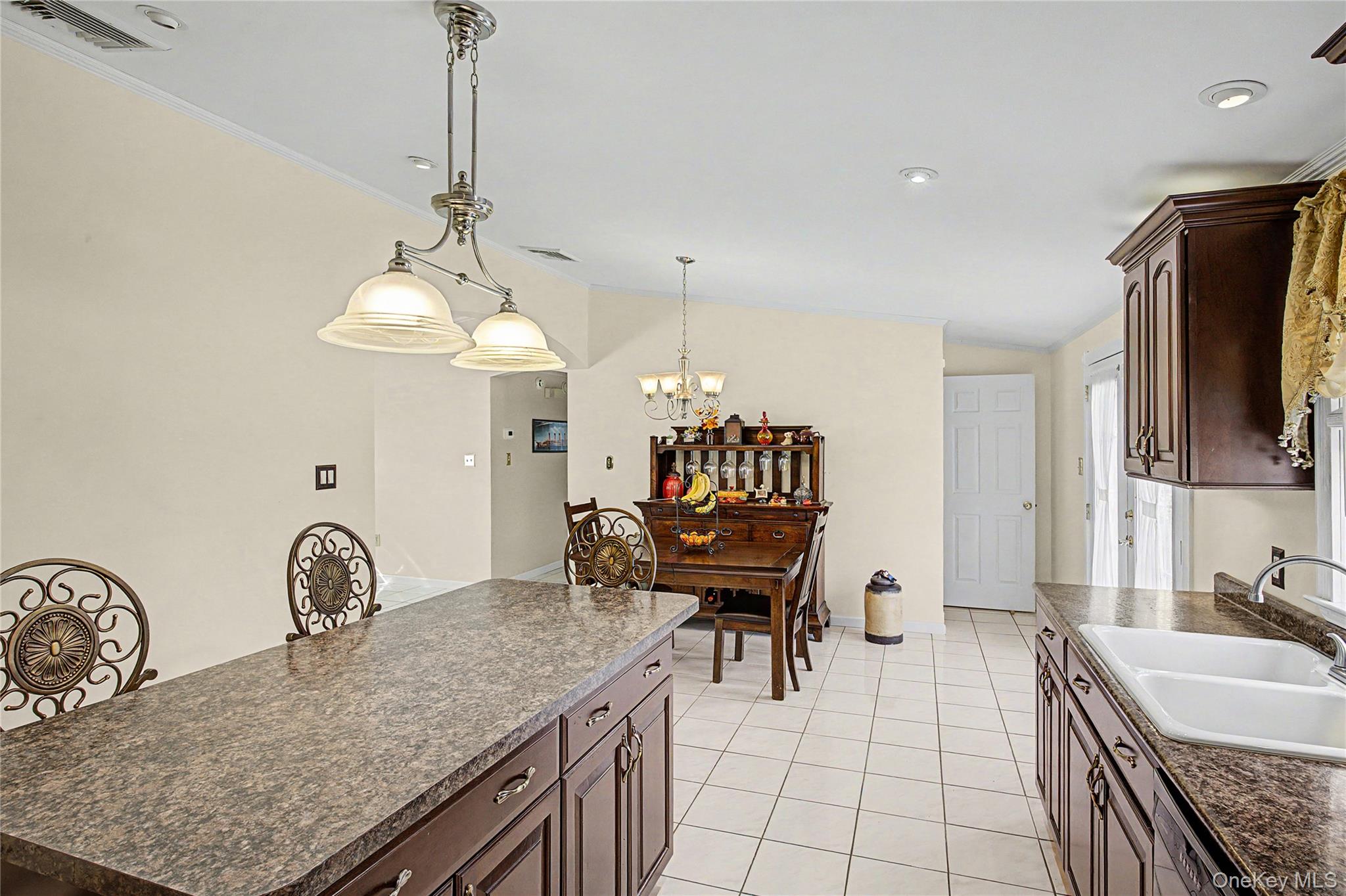 9 South Pond Trail Ridge, NY 11961 - Photo 34 of 40 a kitchen with granite countertop a sink a stove and a refrigerator