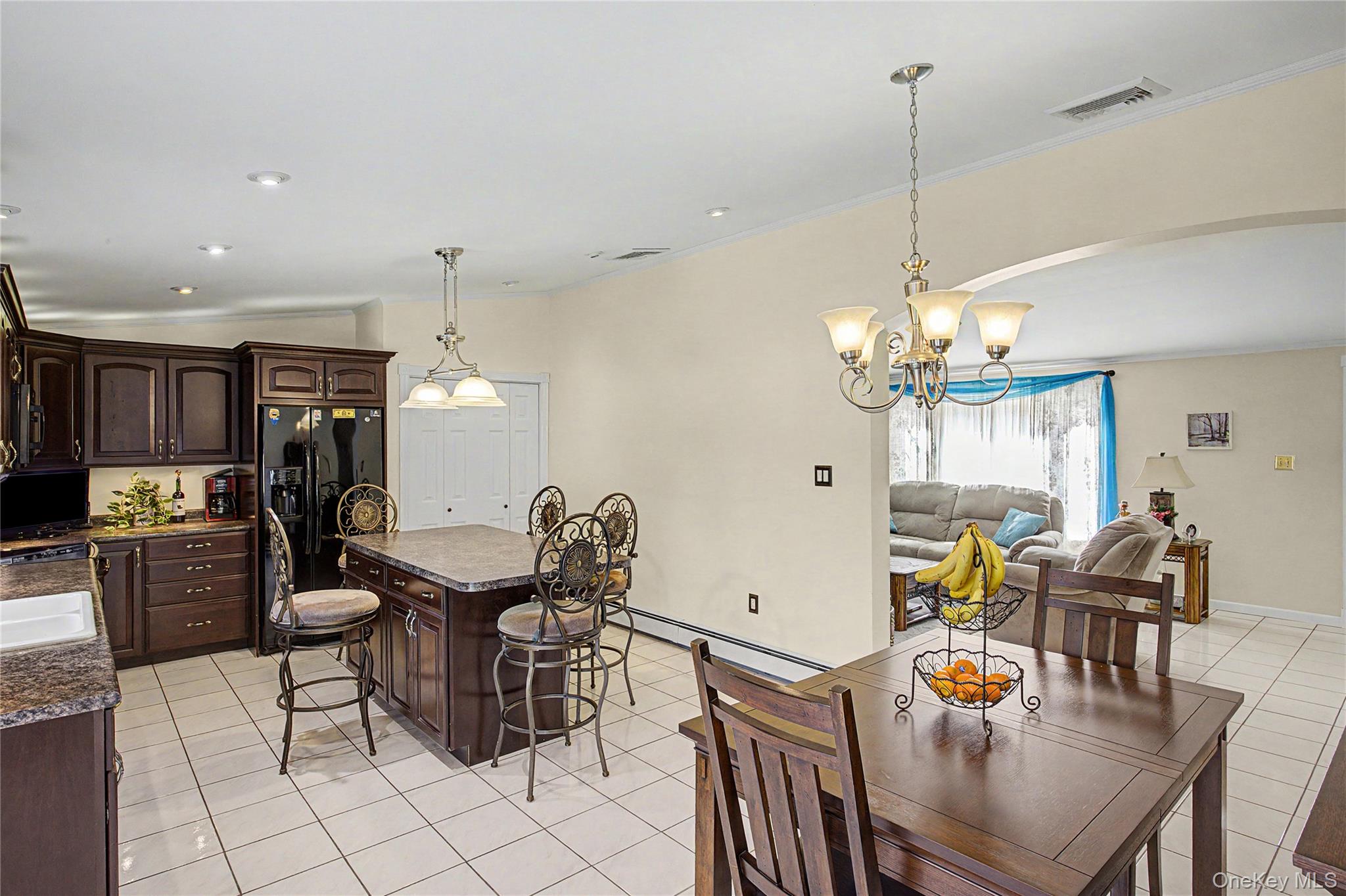 9 South Pond Trail Ridge, NY 11961 - Photo 35 of 40 a dining room filled chandelier and kitchen view