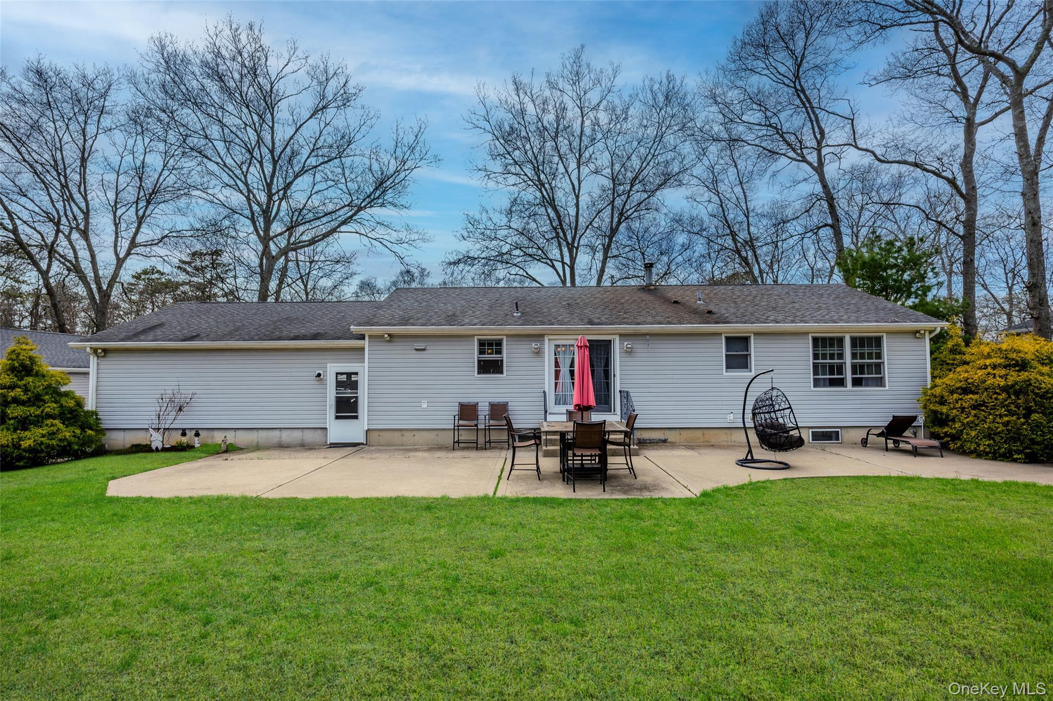 9 South Pond Trail Ridge, NY 11961 - Photo 5 of 40 a front view of house with yard and seating area
