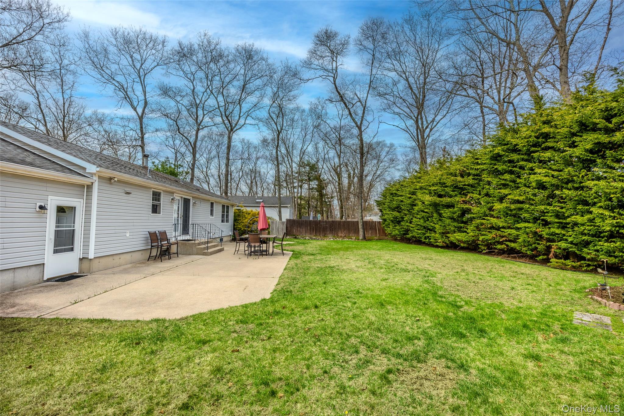9 South Pond Trail Ridge, NY 11961 - Photo 10 of 40 a view of a backyard with potted plants and large trees