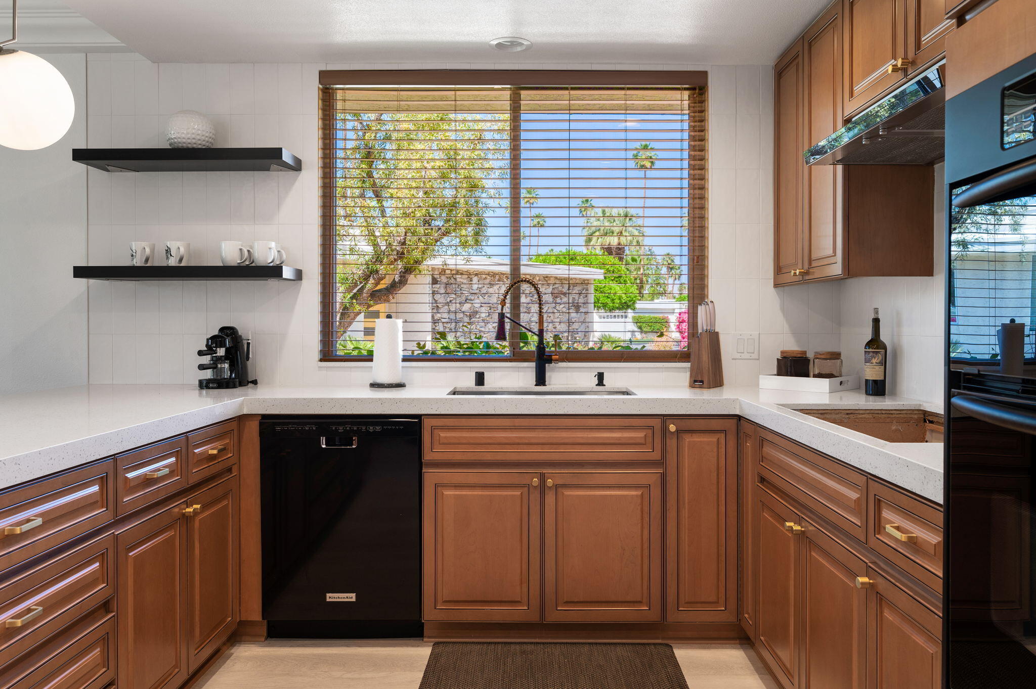 45835 Pawnee Road Indian Wells, CA 92210 - Photo 15 of 46 a kitchen with stainless steel appliances a sink stove and cabinets