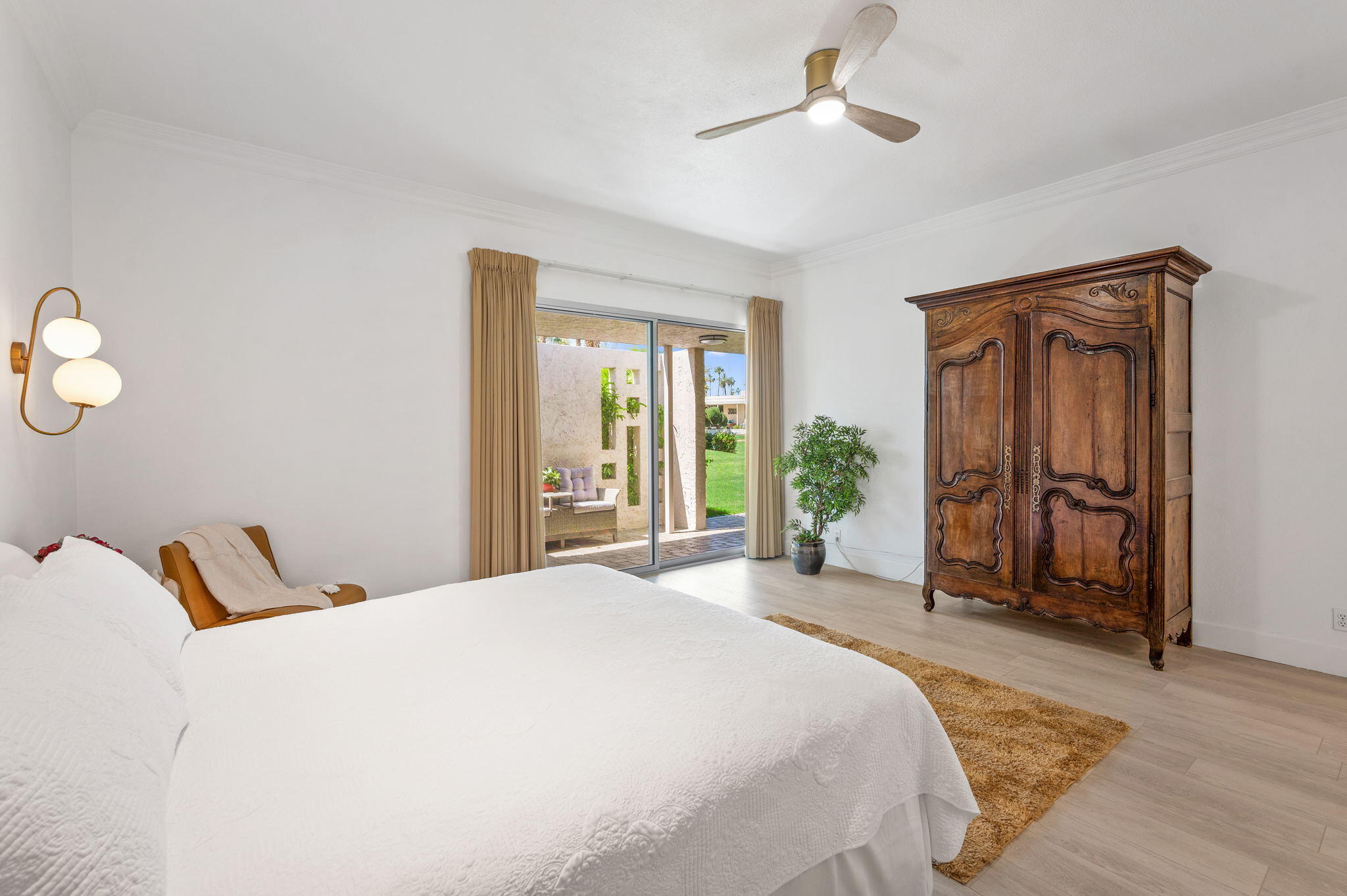 45835 Pawnee Road Indian Wells, CA 92210 - Photo 20 of 46 a bedroom with a bed and a chandelier