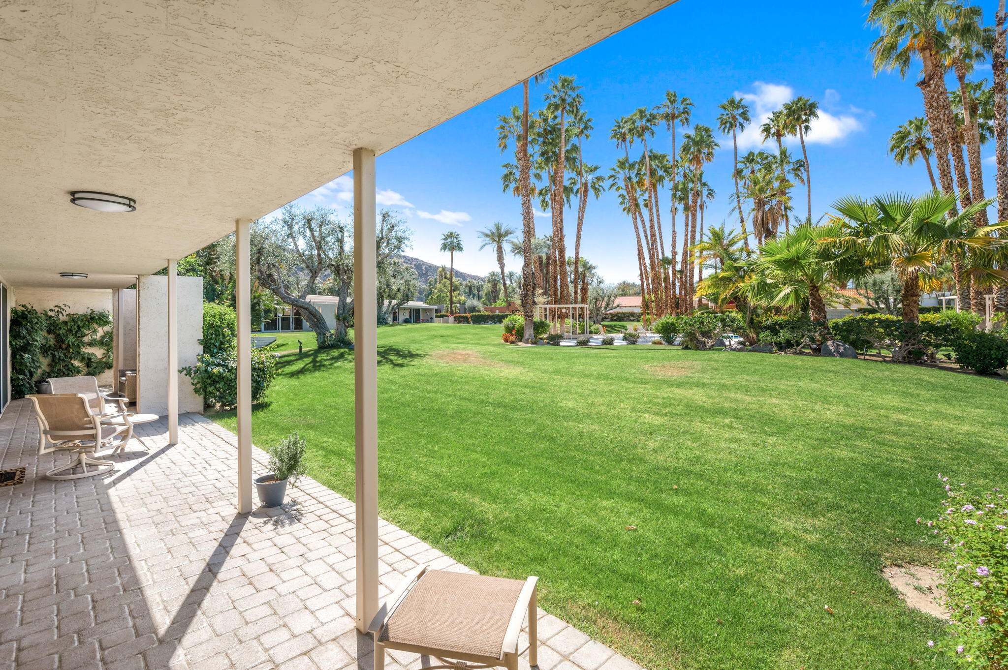 45835 Pawnee Road Indian Wells, CA 92210 - Photo 42 of 46 a view of a chairs and table in patio with a yard