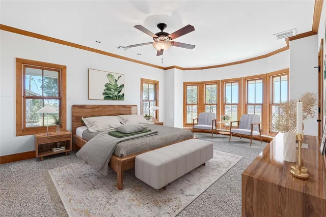 a bedroom with a large bed couch and a large window