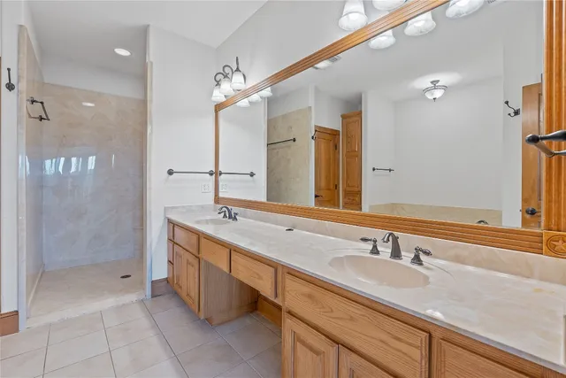 a bathroom with a granite countertop sink mirror and double