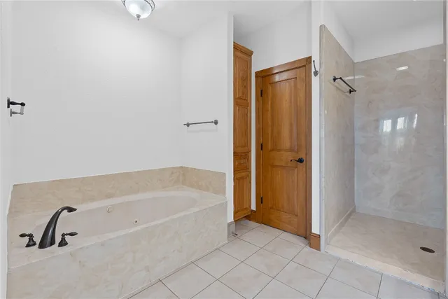 a bathroom with a bathtub and a shower