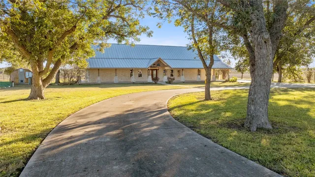 a view of a house with swimming pool and a yard