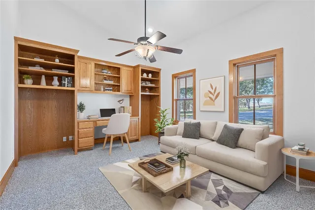 a living room with furniture a lamp and a window